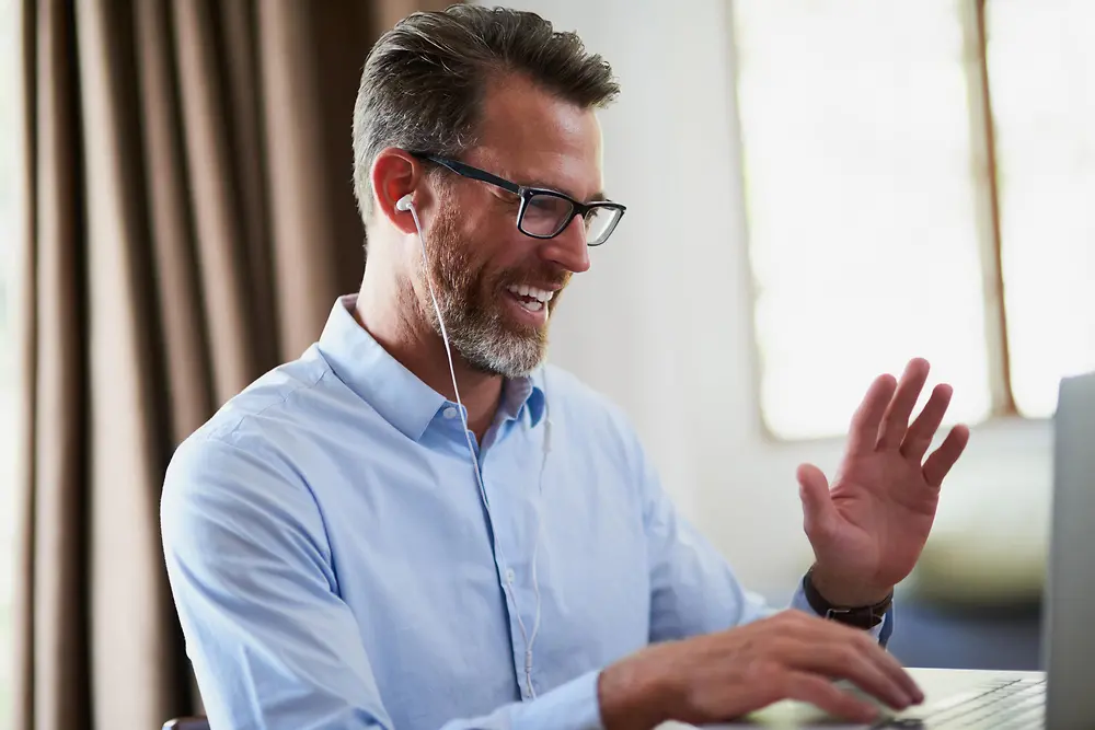 A businessman holding a video conference with his team