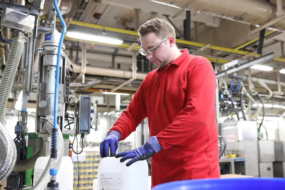 Henkel Employee filling up a canister with disinfectants