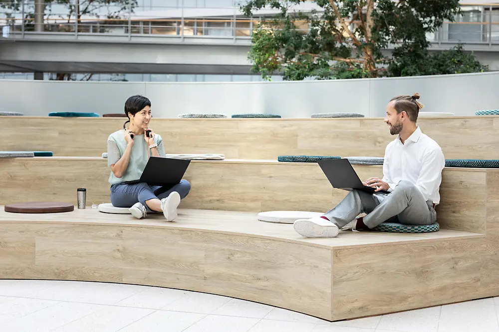 Two colleagues communicating in a modern workplace in the office.