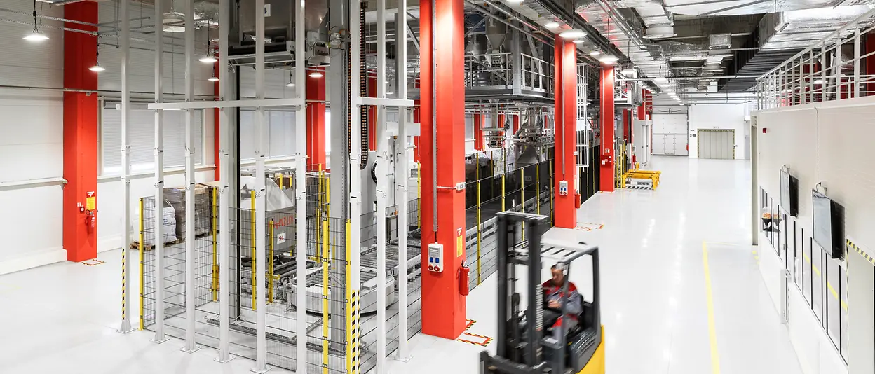 A forklift truck drives through the production halls of Henkel in Kruševac