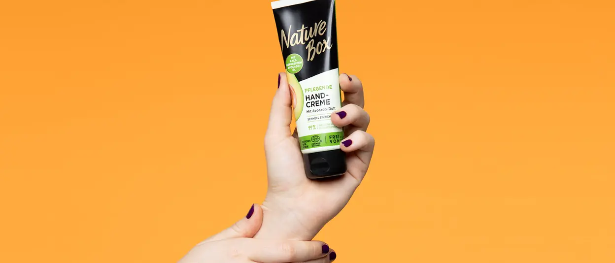 A hand holds the nourishing hand cream from Nature Box