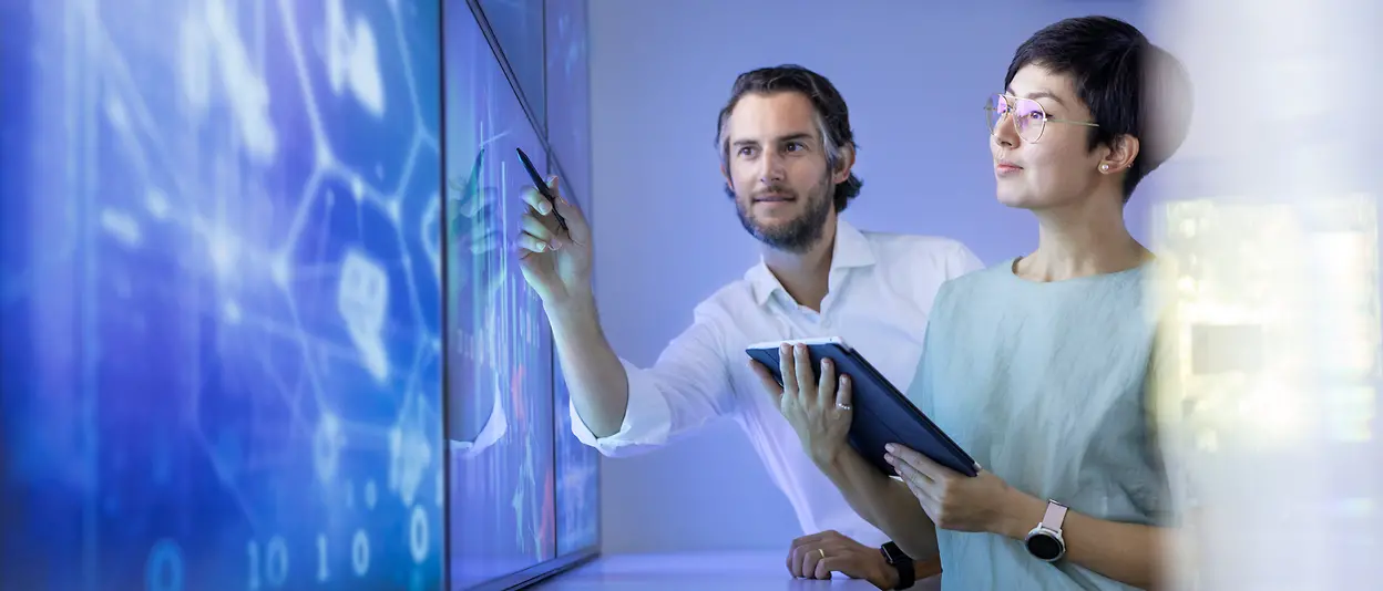 Employees work on large screens.