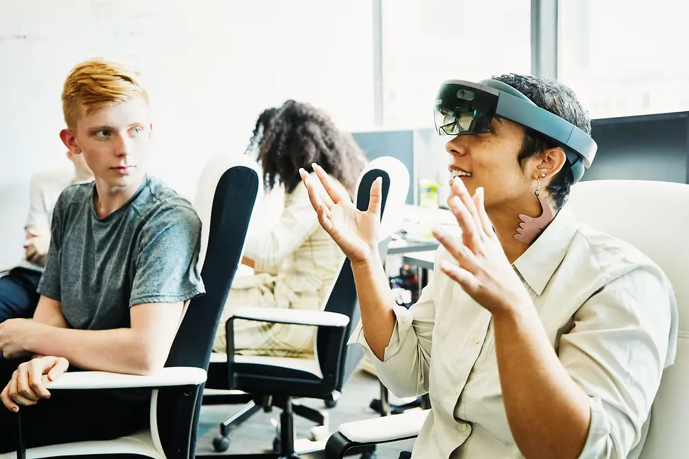 Two employees take part in a training session in which they try out VR glasses.