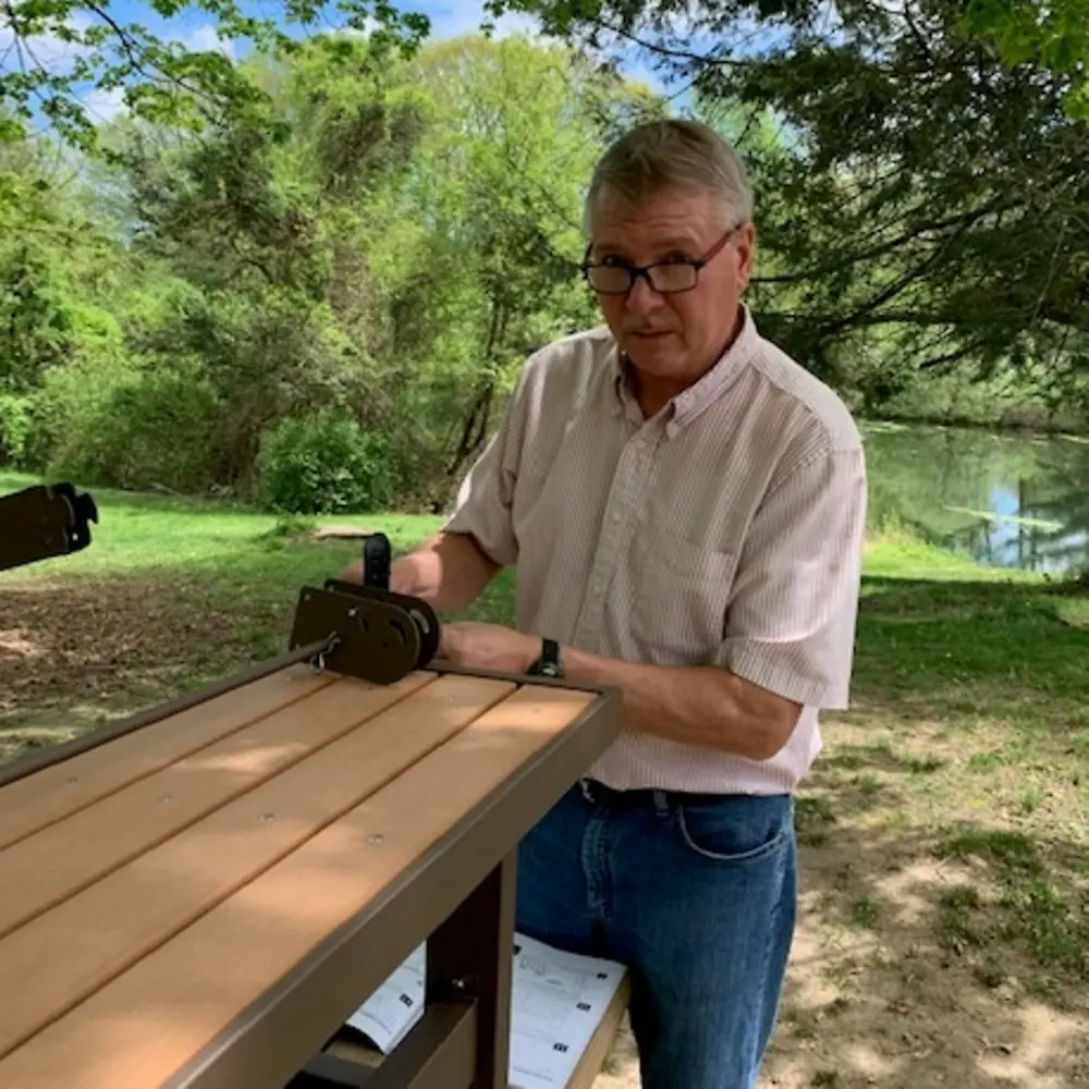 Henkel employee working at a wooden table.
