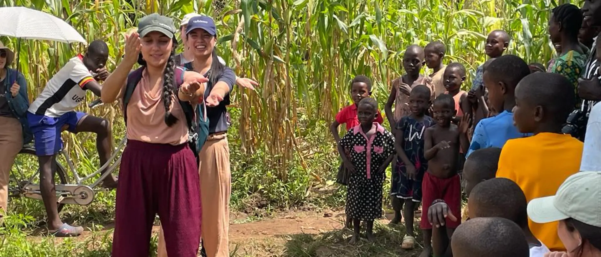 The volunteers teach a group of children the macarena dance.