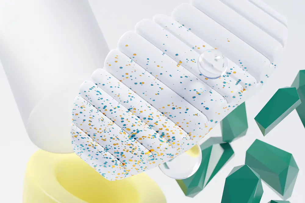 The image shows an abstract assortment of yellow, white and green items of different material to symbolize recyclability.