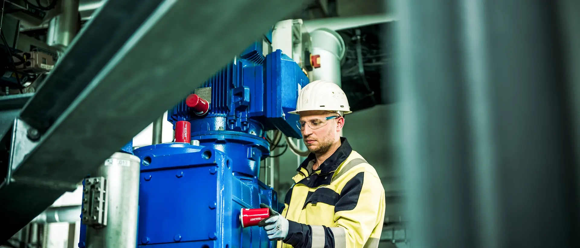 Person checks Loctite Pulse Rotating Equipment in a motor at the Henkel plant in Düsseldorf