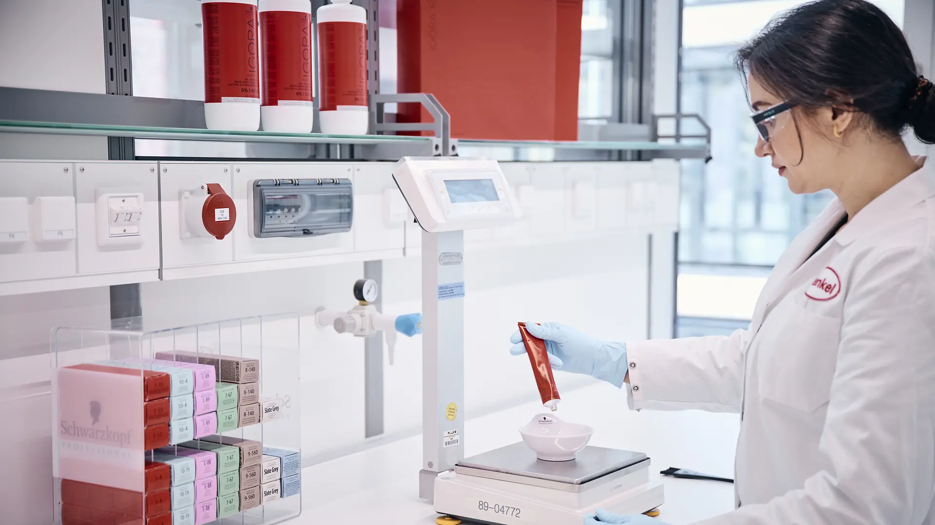 Laboratory employee weighing test products.